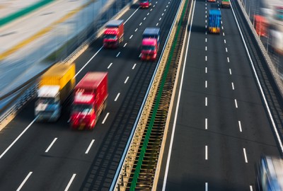 Trucks moving along a freeway.
